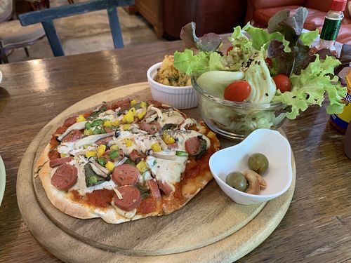 Vegan pizza with mock sausage and yummy side salad at Bonita Cafe and Social Club in Bangkok