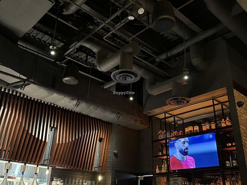 Open kitchen & a big tv  at JINYA Ramen Bar in Burnaby