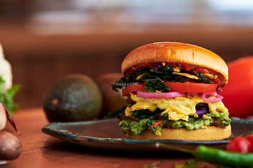 Mexi burger with homemade guacamole, fresh loca seasonal green, pickled onions, pickled cucumber, fresh bell peppers, tomatoes, homemade patty and cheasy sauce and salsa rojo at Nordur in Aalborg