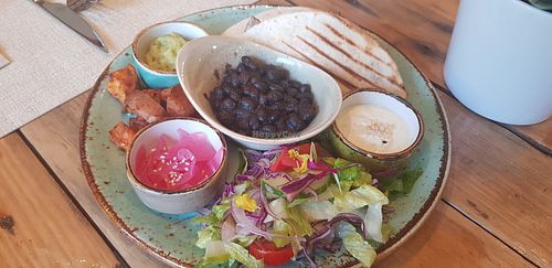 Enchiladas, beans  sweet potatoes, salad and dips at Alubia plant power in Mallorca