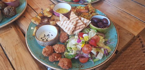 Falafels, hummus, cous cous, potatoes, salad and dips at Alubia plant power in Mallorca