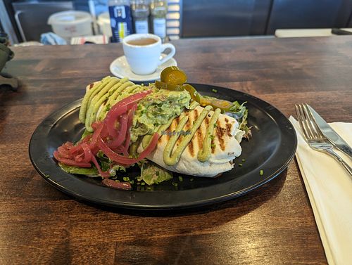 Sweet potato burrito with house raspberry vinaigrette on the garnish that makes it explode. at Highlander Café in Lawrence