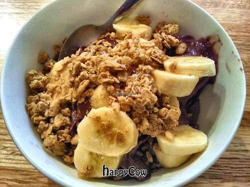 Acai bowl topped with granola, raw honey and sliced bananas. at Roots Organic Juice Cafe in Valparaiso