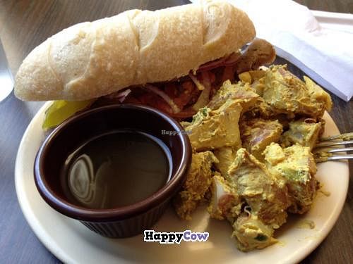 Baguette sandwich with French dip and curry potatoes at Gutenfleischers in Atlanta
