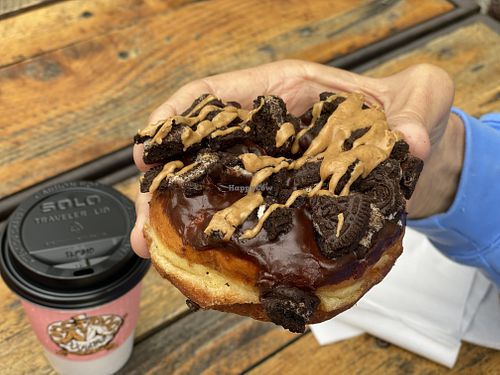Dirt doughnut, covered with chocolate glaze, Oreo pieces and peanut butter drizzle at Voodoo Doughnut Tres in Eugene
