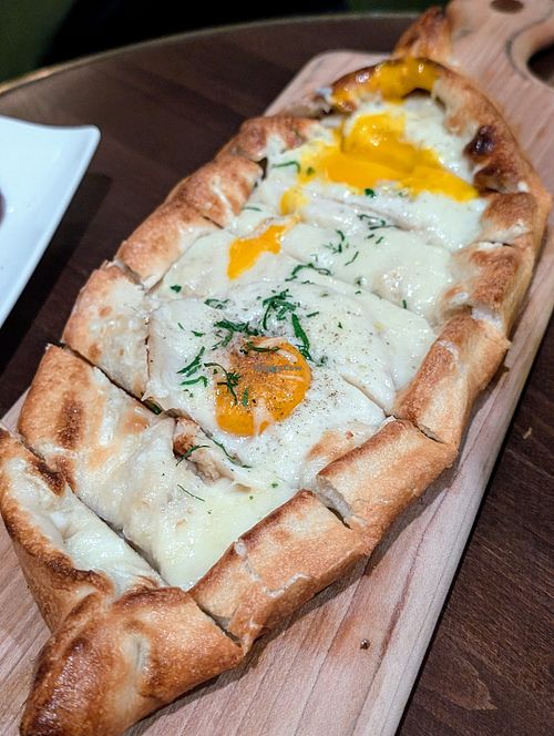 Khachapuri flatbread with vegan cheese and Yo egg at Anixi in New York City