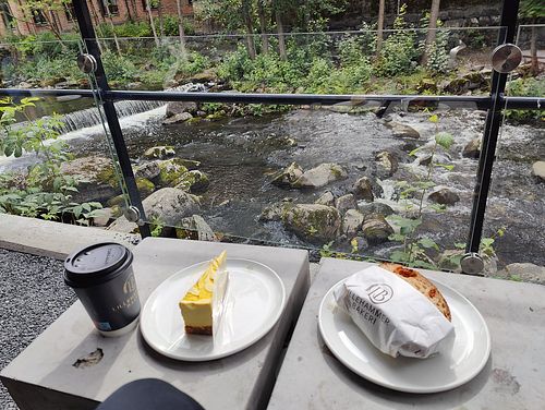 Raw mango cake and hummus sandwich with the view at Lillehammer Bakeri in Lillehammer