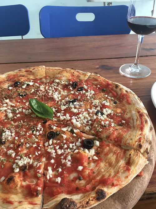 Marinara pizza with lots of garlic, oregano, olives and capers   at Pizzeria da Claudio in Battambang