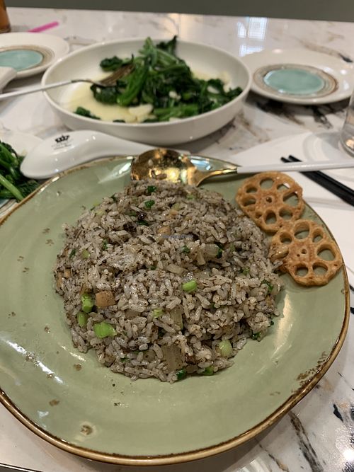 truffle fried rice and stir fried season vegetables in the back  at Supreme Dumplings in Bellevue