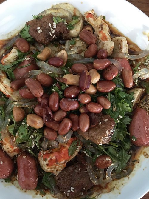 Mock shrimp, mock fish balls, veggie sausage, seitan, thick chewy glass noodles, peanuts, cilantro and sesame seeds in chili sauce  at Chepa Phon Phan Restaurant - ຮ້ານອາຫານເຈປ້າພອນພັນ in Luang Prabang