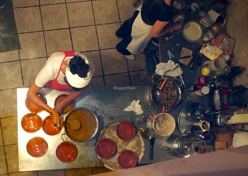 Chef Rita and her assistant, seen from above, preparing the food at Il Colibri in Calci