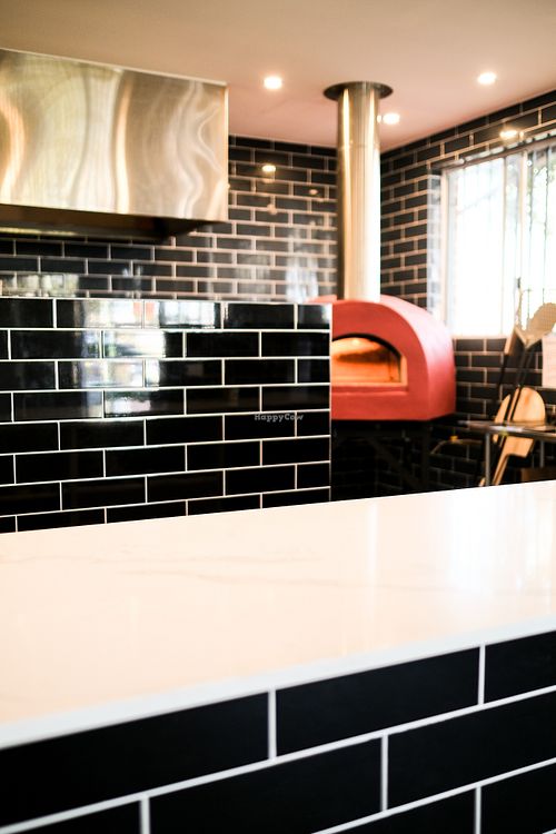 Indulge in the welcoming atmosphere of our newly opened restaurant, highlighted by a stunning wood-fired style oven that adds a unique flavor to our dishes at Papa G's Pizzeria in Blacktown