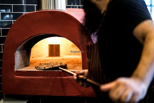 Watch a skilled chef prepare a wood-fired-style vegetarian pizza in a traditional oven. Get ready to savor the authentic Italian flavors at Papa G's Pizzeria! at Papa G's Pizzeria in Blacktown