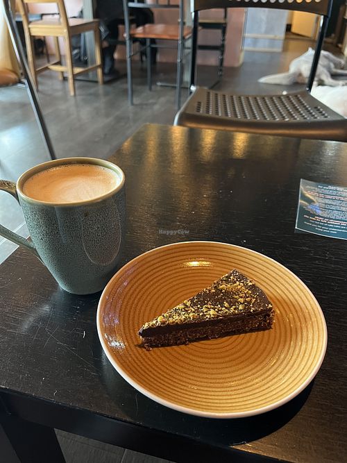 Vegan raw cake and oat milk latte  at Café Huskies in Longyearbyen