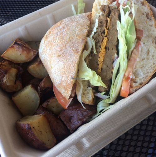 double cheese beast burger, avocado, chipotle cheese and mayo. with a side of roasted potatoes. spot on burger at Vegan Grill - Whole Foods Venice in Venice