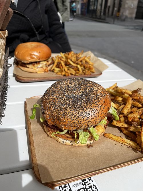 Two plates of burgers and fries  at Ginsburger Vegetarian Superstar in Paris