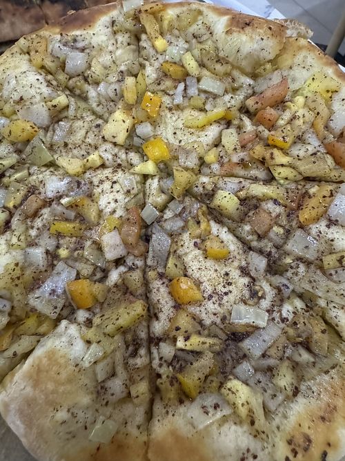 Tomato and onion ‘pie’ (this isn’t cheese!)  at Basha Bakery & Restaurant in Freetown