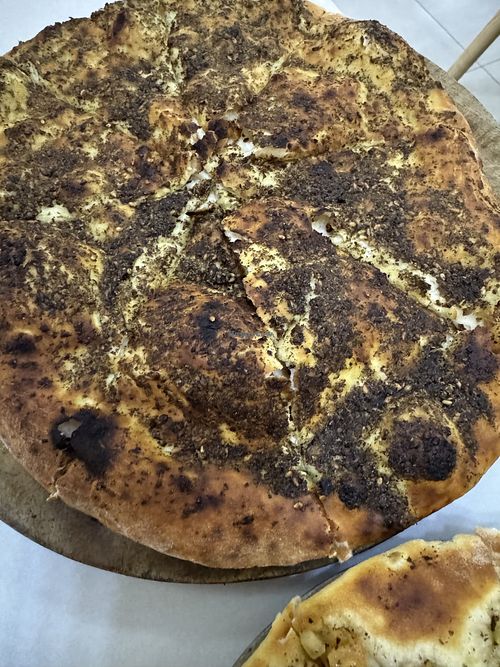 Zatar pie - looks dry but wasn’t at all   at Basha Bakery & Restaurant in Freetown