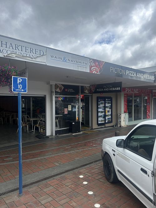 Storefront with covered outdoor seating to left    at Picton Pizza And Kebabs in Picton
