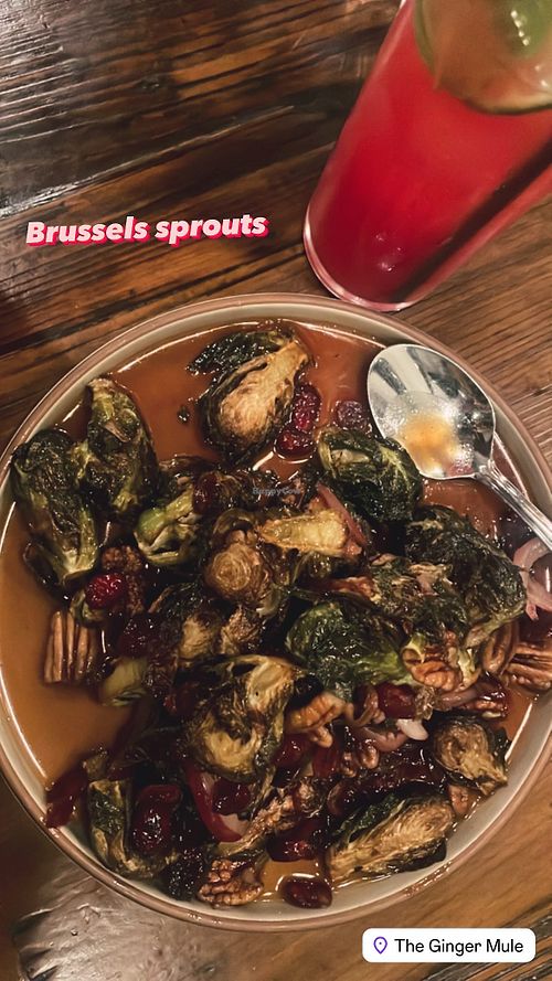 Crispy Brussels sprouts/red onions tossed in a tangy, sweet & lightly spicy sauce w pecans and dried cranberriess  at The Ginger Mule in Houston