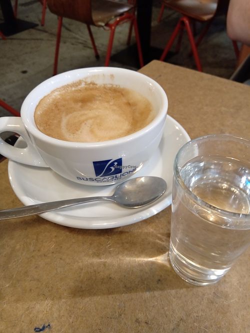 Flat white (July 2025) at AMS - Up To Do Good in Schiphol