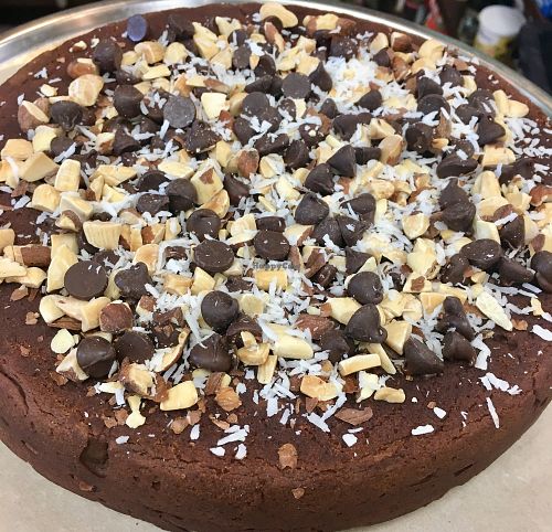 Organic Chocolate Chickpea Cake with coconut shavings, almonds, and chocolate chips on top! at Healthy Thymes Market in Vernon