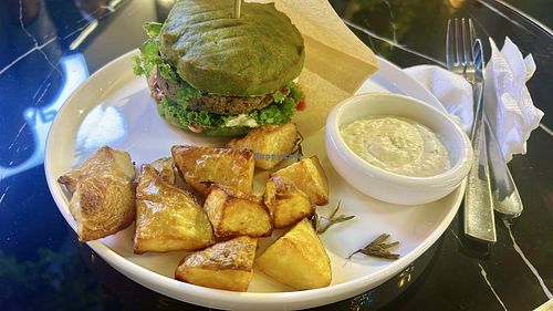 fish burger with potatoes  at PLANTS Kitchen & Bar in Almaty