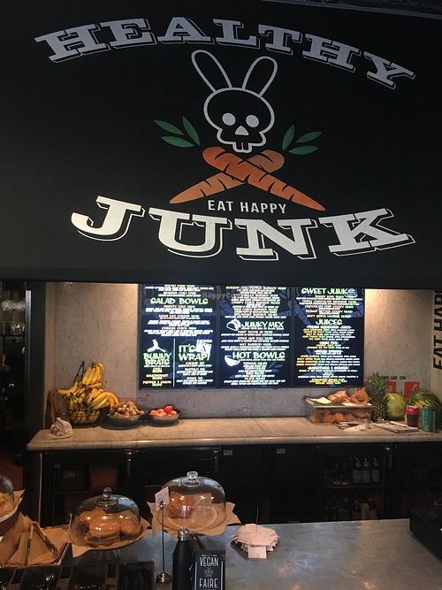 The front of the restaurant. It’s inside a building with big letters on the front that say, “Good Food”. at Healthy Junk in Anaheim