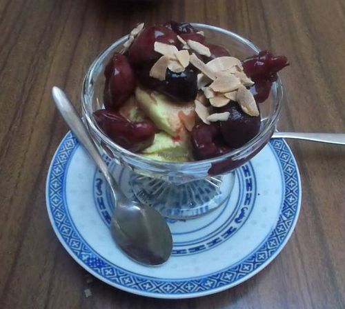 Delicious coconut cream dessert with stewed fruit. at The Food Temple in Lisbon