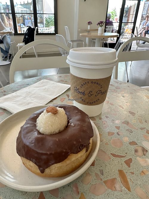 Almond Joy vegan donut and oat milk latte   at Hook and Press in Santa Barbara