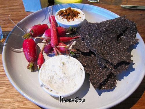 Rye crisps with radishes and dips topped with coconut bacon at M.A.K.E. Raw Cuisine in Santa Monica