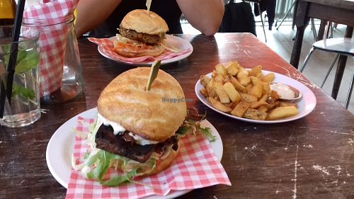 Tofu burger in the front, spicy chickpea burger in the back, with a side order of fries with vegan garlic mayonaise. at Burgertrut in Rotterdam