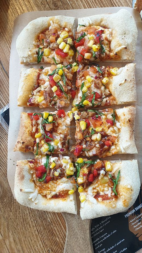 Pizza with vegan cheeze, sweetcorn, tomatoes, onions and jackfruit at Common Meeple Board Game Cafe in Swansea