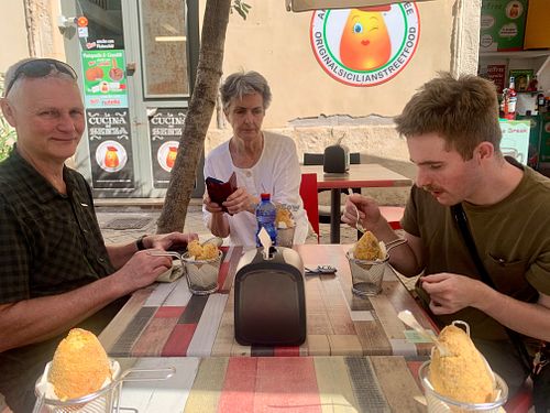 Colin, Sheila, and Elliot loving the arancini - April 2024 at Vegan Food Tour Ortigia in Siracusa