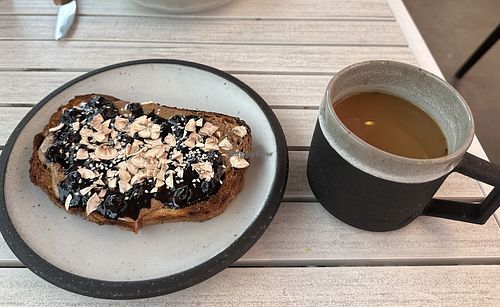 Almond delight toast, americano with oat milk  at Arvo Coffee in Toronto