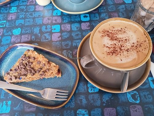 Cappuccino with oat milk and a pecan-flapjack at The Old Butchers in Lochcarron