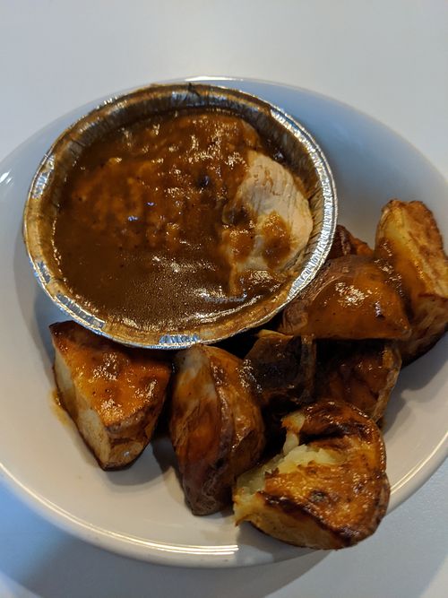 Mushroom pie with gravy and roasted potatoes at World Peace Cafe in Manchester