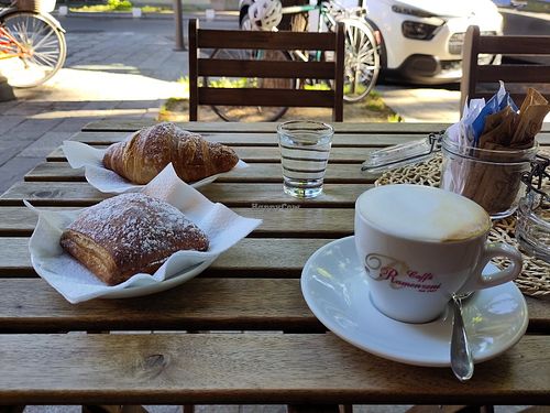 Oatmilk cappuccino, vegan croissant with chocolate and  pastry with almond cream filling. at Vision's Café in Parma