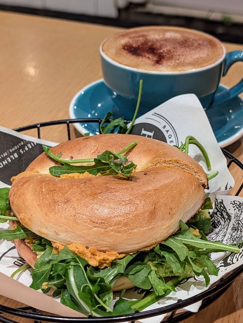 Vegan bagel with hummus and an oat milk cappuccino at R&R Bagels in Hong Kong Island