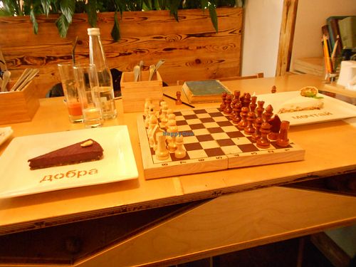 games available, chess game, with coconut dessert and blueberry dessert (vegan) at Cafe Ukrop in St Petersburg