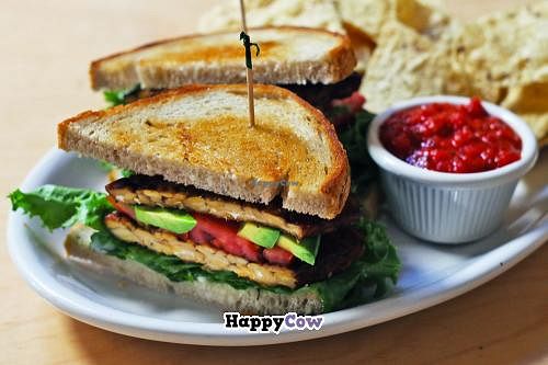TLT Sandwich - served lunches.  Sautéed tempeh, lettuce, avocado, tomato, homemade vegan aioli on toasted sourdough with local Ferndale corn chips and salsa. at Om Cafe in Ferndale