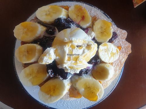 Triple pancakes American style with blueberries, banana and ice cream with maple syrup loaded at Dimpsy's Diner in Plymouth