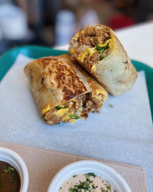 Our vegan Sunrise Burrito: Just Egg, Violife “cheddar” cheese, Uncut vegan sausage & hash browns. (No longer served with arugula) Comes with our Vegan chipotle rosemary aioli! at Whale Bites Cafe in Depoe Bay