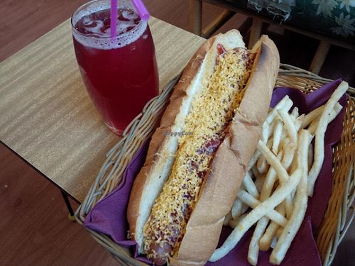 Red Hot Dawg with tomato sauce, vegan cheese, and fries on the side. at Two-Bit Villains in Adelaide