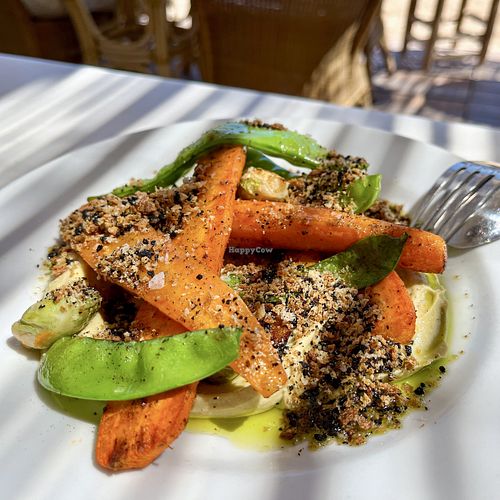 Charcoal roasted carrots on avocado cream with Brussels sprouts, snap peas, bread and black olive crumbs  at Patiki Beach Bar & Kitchen in Mallorca