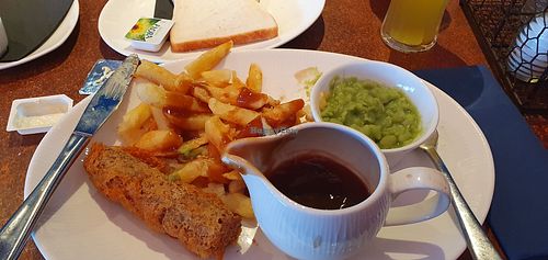 Battered vegan sausage,  chips, mushy peas,  vegan gravy, bread & margarine at The Ocean Fish and Chip Restaurant in Preston
