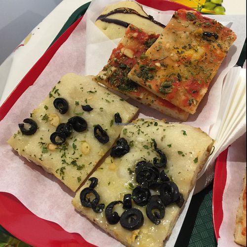 2 types of vegan pizza with a vegan calzone hiding in the back at Primo Basilico in Lisbon