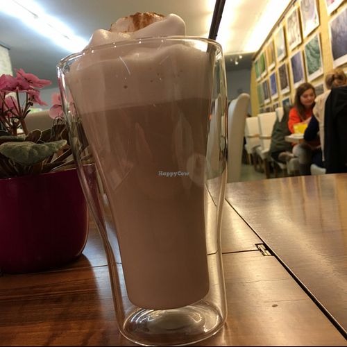Chai latte; 'food crystal' art photos on the wall at Vegelateria in Zurich