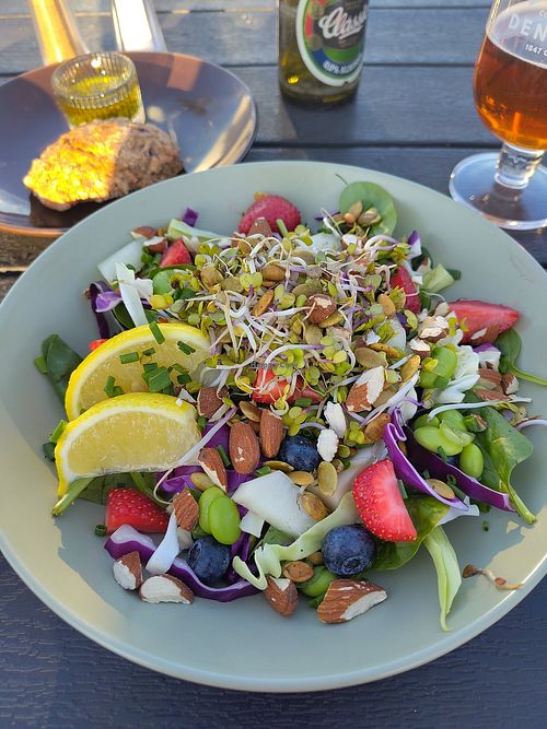 Beautiful, colourful and tasty salad. The bread roll was warm and very good. at Cafe Møller in Hirtshals