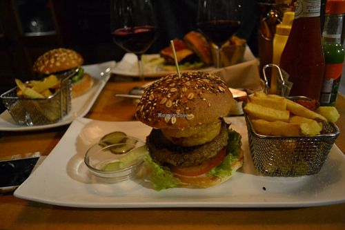 The burger I got, not entirely sure if everything on the burger was vegan besides the patty because they served it with a side of non-vegan sauce, which makes me think the onion rings could have a non-vegan batter.  at Zombie Bar in Madrid